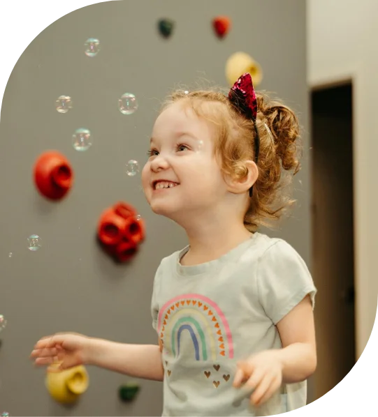 Therapist playing with a baby on a foam mat