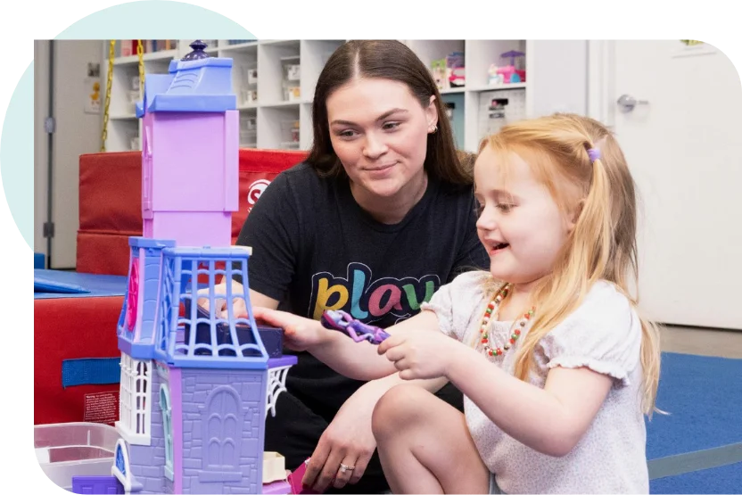 Therapist engaging in creative play with toddler