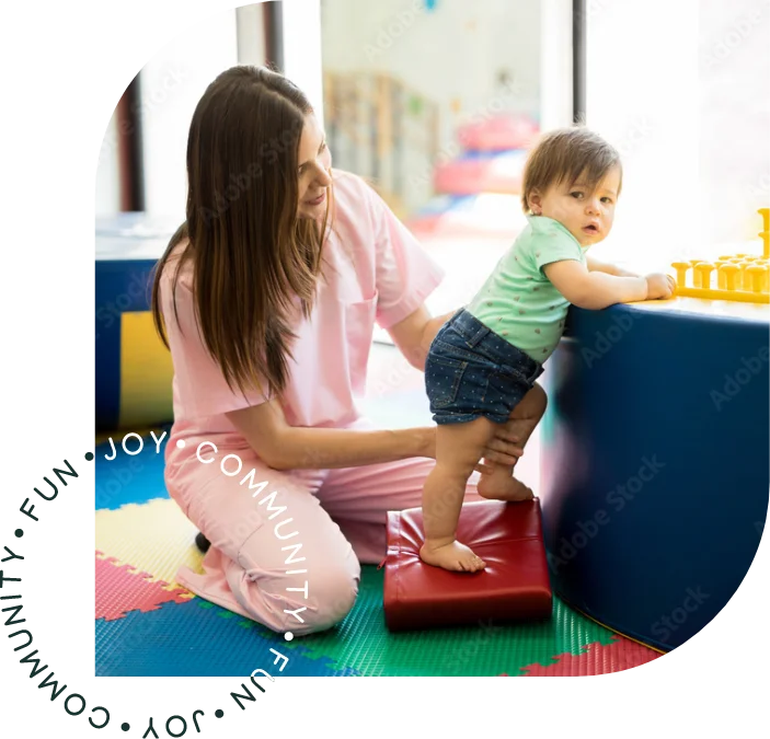 Therapist working with a young child in a colorful play area