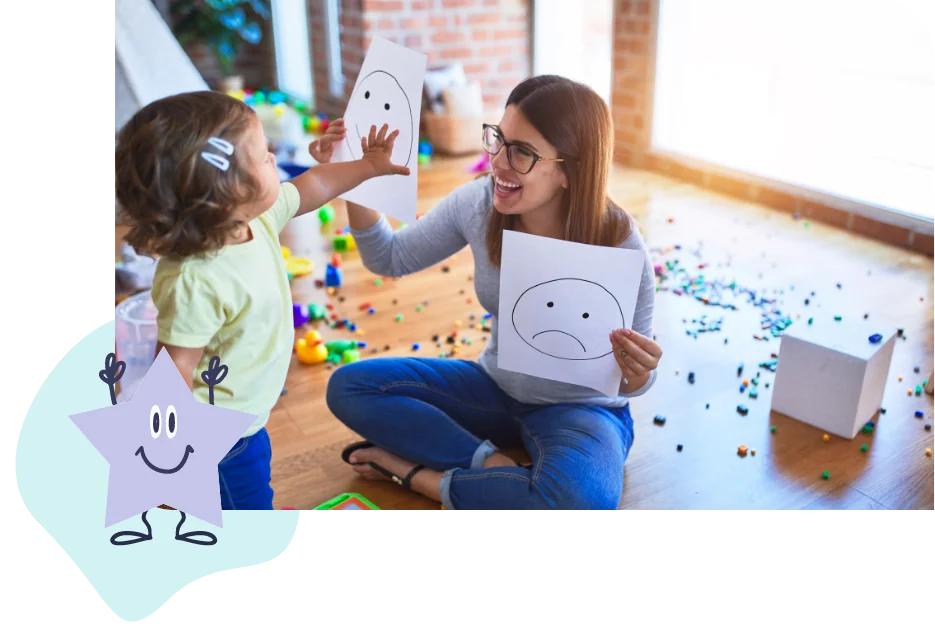Therapist and child playing with happy and sad face drawings