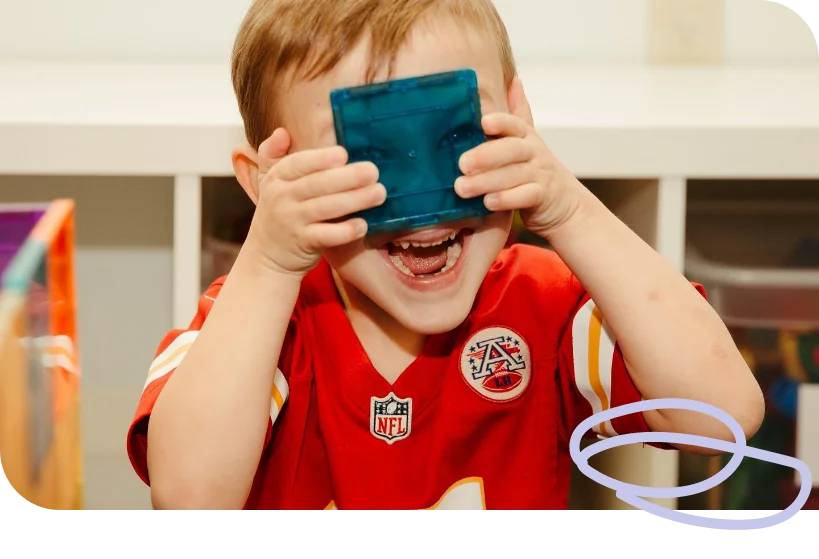 Therapist engaging in creative play with toddler