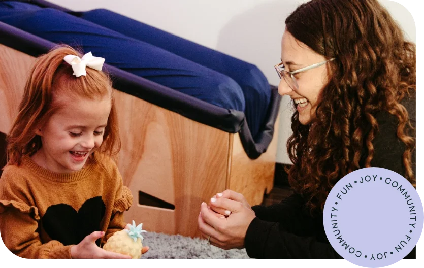 Therapist engaging in creative play with toddler