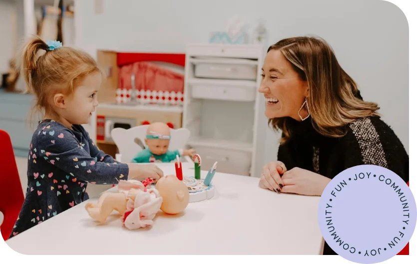 Therapist engaging in creative play with toddler