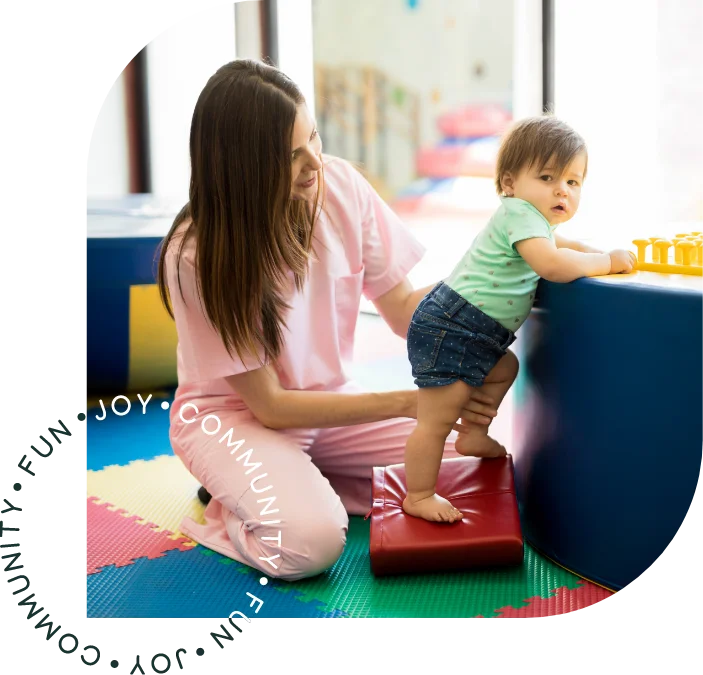 Therapist working with a young child in a colorful play area